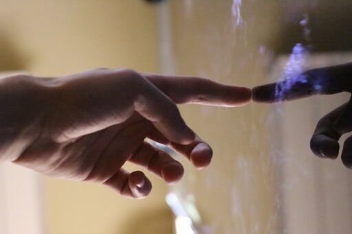 A hand interacting with a touch screen